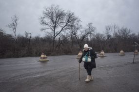A woman crosses a border crossing point