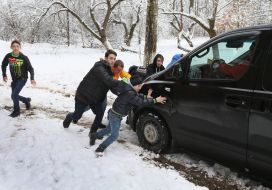Pupils of a boarding school are pushing a car