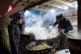 The cook prepares shish kebabs and pilaf