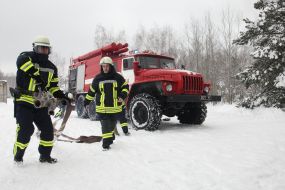 Rescuers pull the fire hose