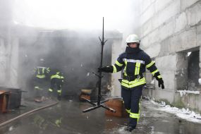 Rescuer takes out a burnt Christmas tree