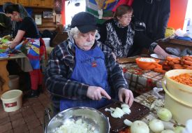 A man is cutting an onion