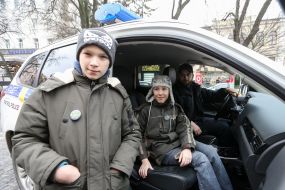 A boy in a patrol police car