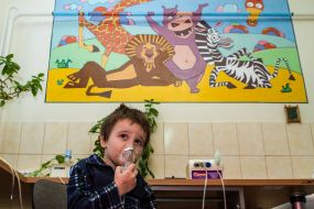 The boy is testing a modern inhaler