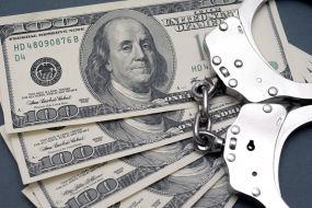 100-dollar bills and handcuffs