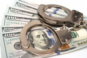 100-dollar bills and handcuffs