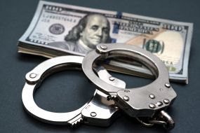 100-dollar bills and handcuffs