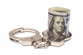 100-dollar bills and handcuffs