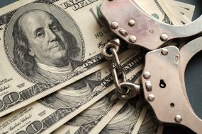 100-dollar bills and handcuffs