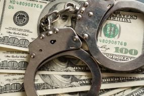 100-dollar bills and handcuffs