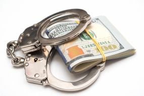 100-dollar bills and handcuffs