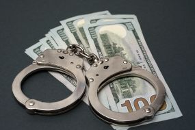 100-dollar bills and handcuffs