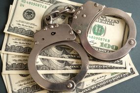 100-dollar bills and handcuffs