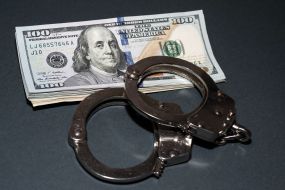 100-dollar bills and handcuffs
