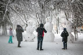 People photograph snowmobiles