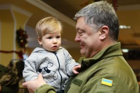 Petro Poroshenko holds the boy in his arms