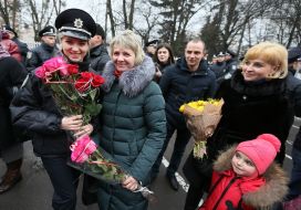 A patrol police officer with flowers