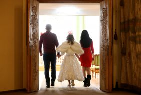 A couple of Natalia and Igor with a girl in the costume of an angel