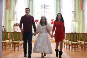A couple of Natalia and Igor with a girl in the costume of an angel
