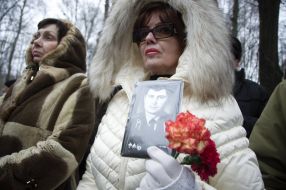 Relatives of warriors killed in Afghanistan hold their portraits