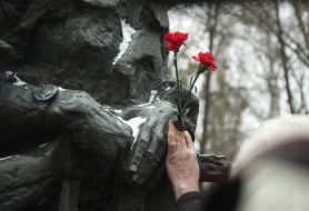 Laying flowers to a monument to dead soldiers in Afghanistan