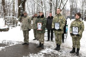 Servicemen hold portraits of soldiers killed in Afghanistan