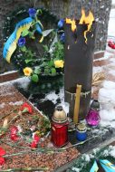 Flowers and lamps near the monument to soldiers who died in Afghanistan