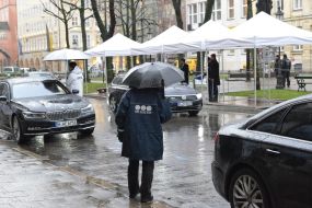 A security guard with umbrella