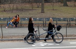 Girls rolling a bicycle-tandem