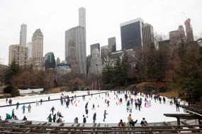 People ride on an ice rink