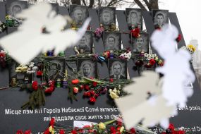 Flowers and lamps near the photos of the Heroes of Heavenly Hundreds