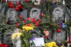 Flowers and lamps near the photos of the Heroes of Heavenly Hundreds