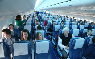 Guests of the presentation in the cabin of Boeing 777-200 ER