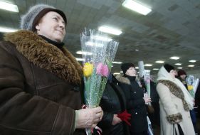 The woman holds flowers