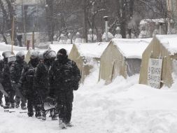 Law enforcers conduct investigative actions in a tent camp