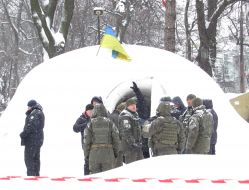 Law enforcers conduct investigative actions in a tent camp