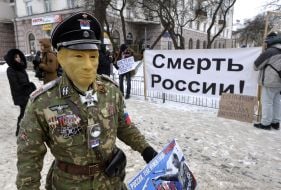 Participant of the action in Putin's mask and military uniform
