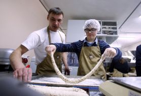 A boy with Down syndrome is preparing a batch