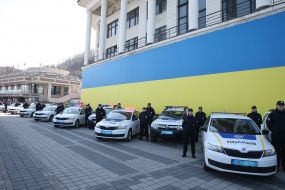 Police officers near official cars