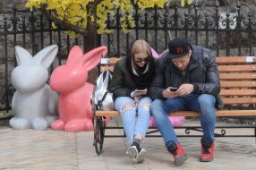 Young people are sitting on a bench