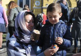 Girl and boy holding pysanka