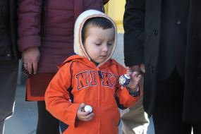 The boy is holding pysanka