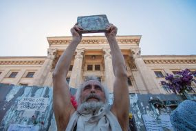 A man with an icon near the House of Trade Unions