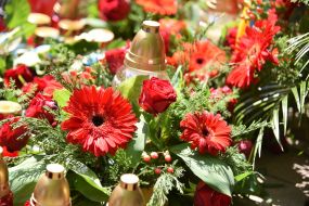 Candles and flowers near the Memorial Cross