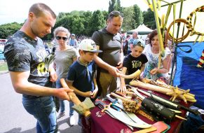 People consider the products presented at the fair