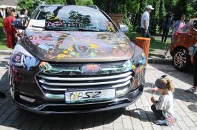 Children paint a car