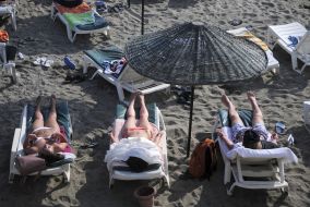 People rest on the beach in Alanya (Turkey)