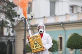 Participant of the action holds a model of electronic cigarette