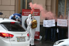 Participant of the action holds a model of electronic cigarette