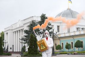 Participant of the action holds a model of electronic cigarette